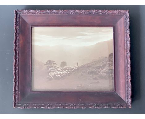 A 1920s Walmsley's Series sepia photographic print depicting a shepherd and flock on a fellside, in period wooden frame under