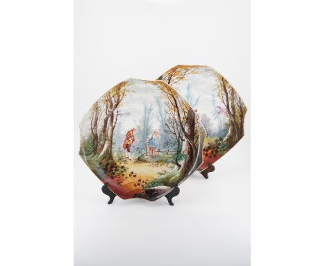 A pair of continental porcelain wall plaques, each depicting an 18th Century couple in a woodland setting, late 19th / early 