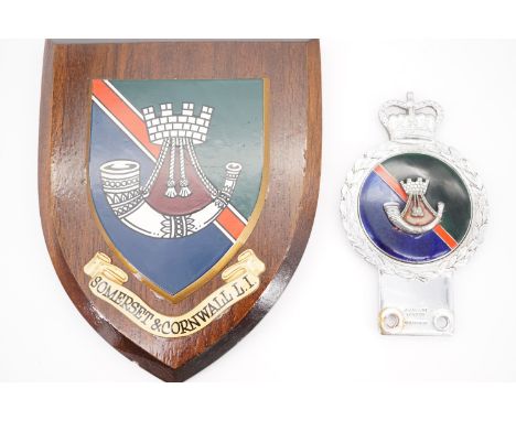 A Somerset and Cornwall Light Infantry car bumper badge by Gaunt, together with a related wall plaque