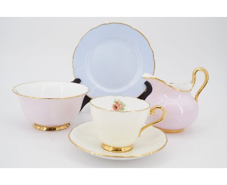 An Aynsley tea set, uniformly hand-enamelled in a floral pattern, decorator's monogram MBM, the cups Aynsley, jug and sugar b