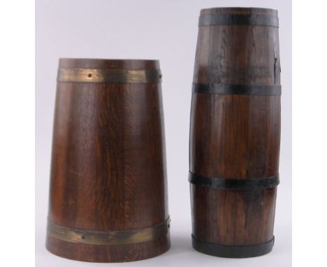 A brass and oak coopered barrel stick stand, height 48cm and an iron bound oak stick stand, height 60cm, (2).