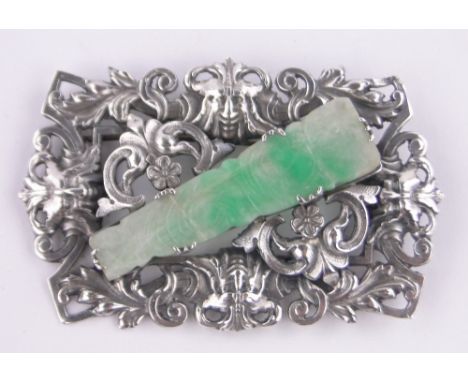 A large cast silver classical design brooch, with inset relief carved jade panel, length 72mm.