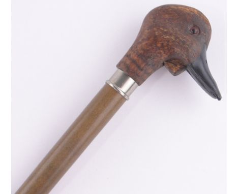 A carved and stained wood duck's head design walking stick, with quacking beak.