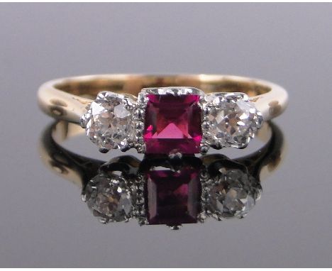 A 3 stone square cut ruby and diamond ring, unmarked gold settings, setting width 12mm, size K.