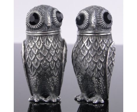 Pair of continental silver novelty owl pepperettes, ruby glass eyes, marked 800, height 6.5cm.