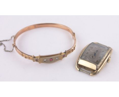 An Edwardian 9ct gold hinged bangle, and a gent's gold plated Bulova Art Deco wristwatch, (2).