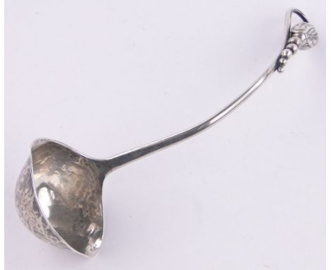 A Georg Jensen blossom pattern silver cream ladle, import marks London 1924.