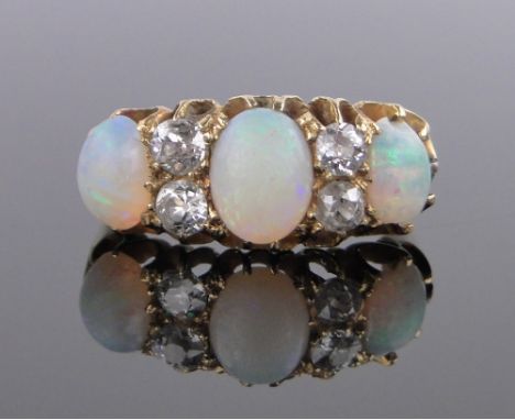 An 18ct gold 7 stone opal and diamond set ring, central opal height 8mm, setting width 22mm, size N.