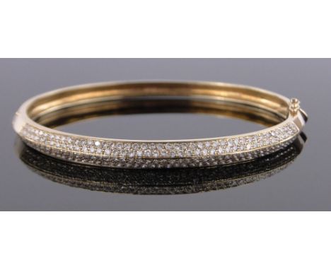 An 18ct gold hinged bangle set with approx. 2cts diamonds, 16.45g.