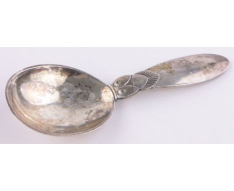 A Georg Jensen silver caddy spoon, cactus pattern, dated 1931, length 9.5cm.