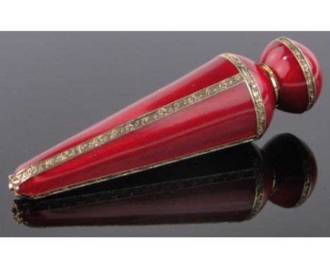 An unmarked gilt metal and red enamel perfume flask, length 10cm.