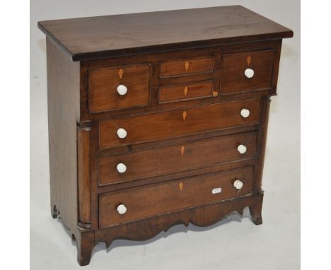 An early 19th century mahogany table top chest of drawers, with 4 short and 3 further long drawers under, ceramic handles, br