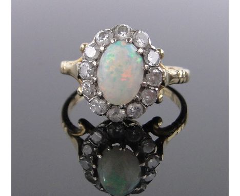 An 18ct gold opal and diamond cluster ring, setting height 12mm, size L.