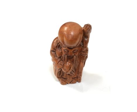 A carved Chinese hardwood netsuke - Village elder with club