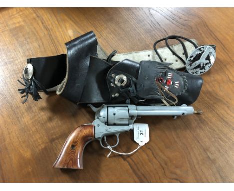A replica Colt Single Action Army blank firing revolver with western style gun belt