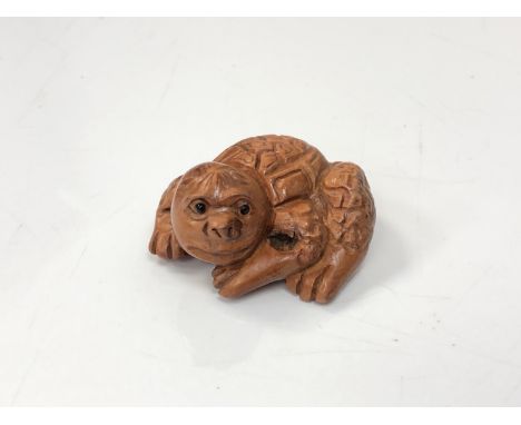 A carved Chinese hardwood netsuke - Mythical beast 