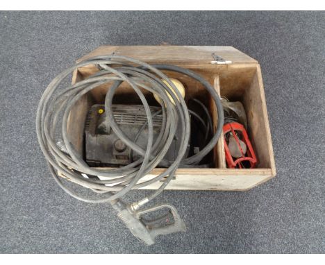 A pressure washer with accessories and workshop light in a fitted box 