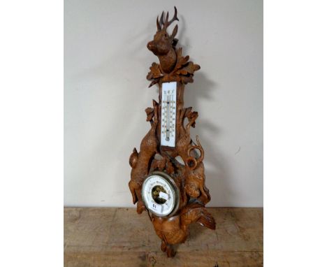 A late 19th century Black Forest carved oak hunting-themed barometer&nbsp;