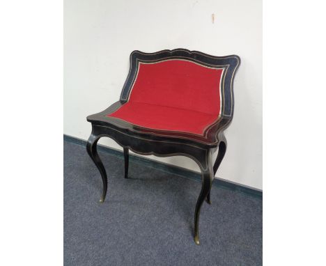 A contemporary black and gilt turnover top card table 
