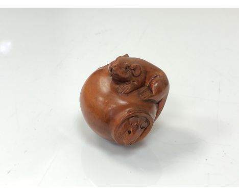 A carved Chinese hardwood netsuke - Two rats on a pot 