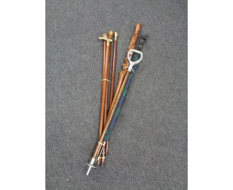 Two bundles of walking canes, umbrella with Scottie dog handle, shooting stick etc 