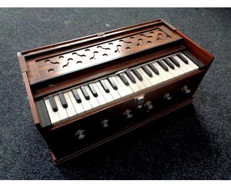 A wooden cased travelling harmonium 