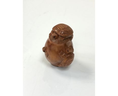 A carved Chinese hardwood netsuke - Turtles on a pot