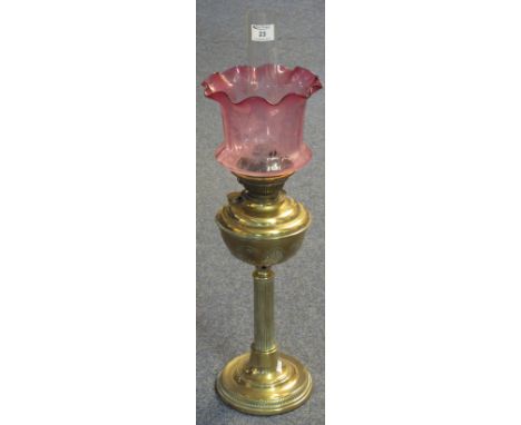 Early 20th Century brass Corinthian column oil lamp with cranberry, florally etched shade and clear funnel.(B.P. 24% incl. VA