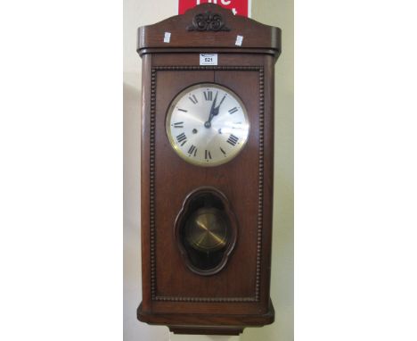Mid 20th Century oak two train wall clock with key and pendulum.(B.P. 24% incl. VAT)
