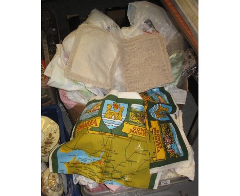 Two boxes containing bed linen and tableware including: floral printed bed sheets, plain bed sheets, crocheted doilies and ta