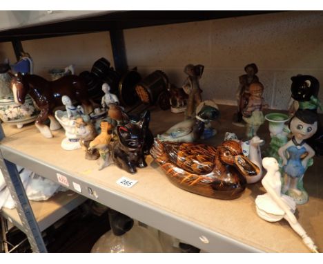 Shelf of mixed animals and figurines
