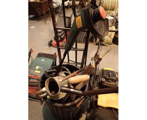 Bin of garden tools spade forks two galvanised watering cans and a Black and Decker strimmer