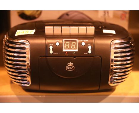 Black 3 in 1 FM/AM radio, CD and cassette player, boxed GPO PCD299. Not available for in-house P&PCondition Report: This item