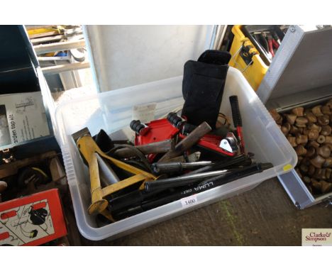 A plastic box containing bicycle pumps; tools; single axle stand etc