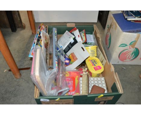 A box containing various sundry items to include table tennis balls; travelling clock; sewing set etc
