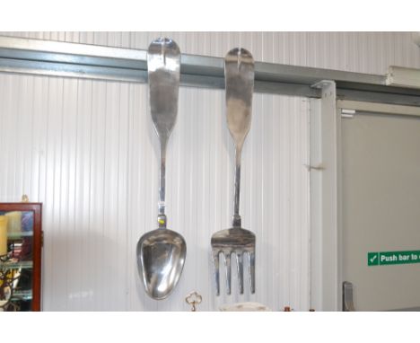 A large decorative fork and spoon