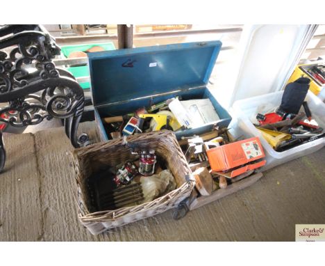 A blue box of tools; another box of tools and a wicker basket containing fishing items