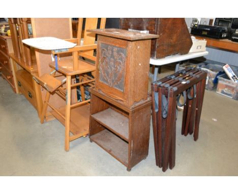 A carved oak cupboard attached to a two tier book shelf