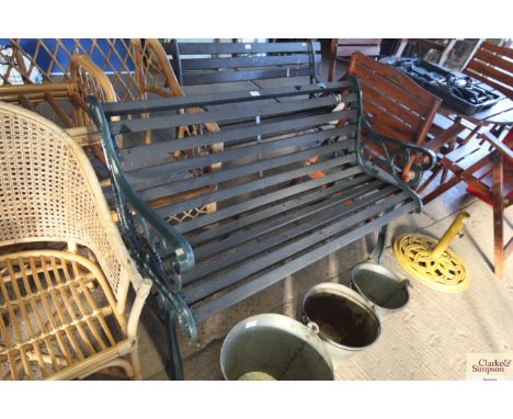 A large slatted garden bench with ornate ends