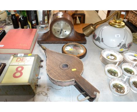 An oak cased two-hole mantel clock, pair of bellows, a convex mirror