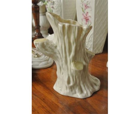 BELLLEK/CERAMIC/IRISH: An unusual tree trunk shaped Belleek vase. Measuring approx. 6.5' high. Cream body with yellow lustre 