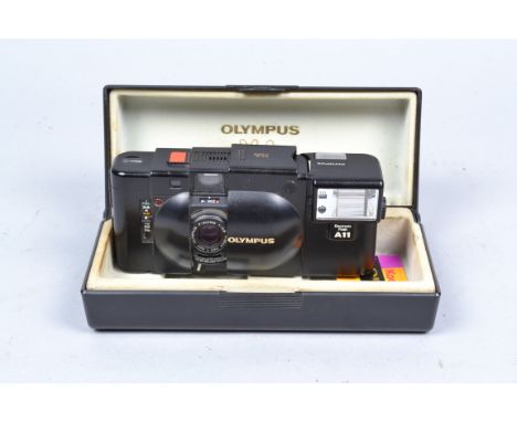 An Olympus XA Compact 35mm Rangefinder Camera, corrosion to battery compartment with A11 electronic flash and maker's present