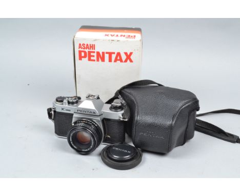 An Asahi Pentax K1000 SLR Camera, shutter working, meter responsive, body G-VG, with SMC Pentax M 50mm f/2 lens, barrel G-VG,