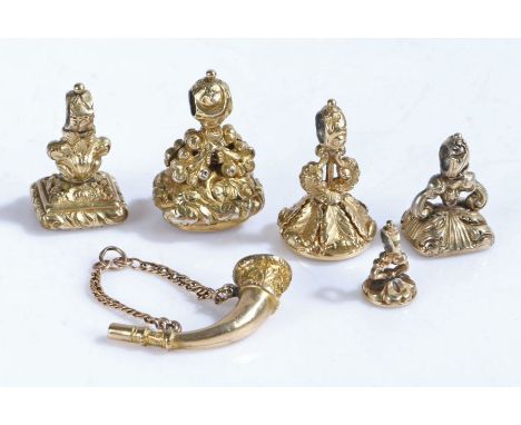 Collection of six gilt fob seals, to include example modelled as a bugle, three with carved intaglios depicting a dog running