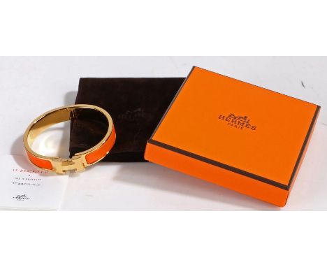 A Hermes Clic H bracelet, orange enamel and rose gold plated, with original suede pouch and box, 6cm&nbsp; wide