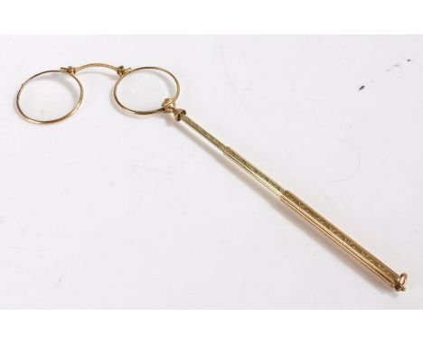 Pair of gilt metal lorgnettes, the three drawer telescopic handle with engine turned and scroll decoration terminating in the