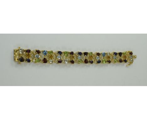 Multi Gemstone Openwork Bracelet, comprising 30.5cts of rhodolite garnet, red garnet, peridot, Swiss blue topaz, sky blue top
