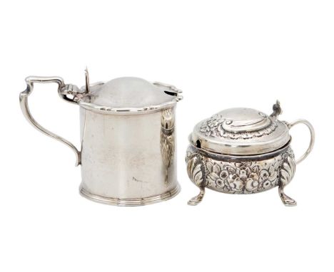 Two Victorian silver hinge lidded mustard pots. One circular embossed on triple feet by Josiah Williams &amp; Co, Exeter 1878