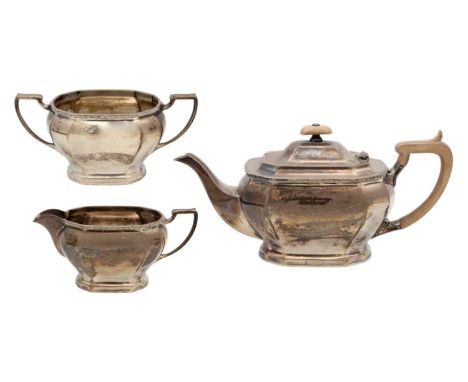 A George VI silver three piece tea set by Cooper Brothers & Sons Ltd. Of oblong canted form, Sheffield 1942, teapot length 29