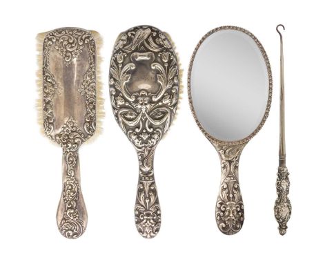 A Victorian silver dressing table set. Includes two brushes, hallmarked London 1896, a mirror, Birmingham 1905, by Henry Matt